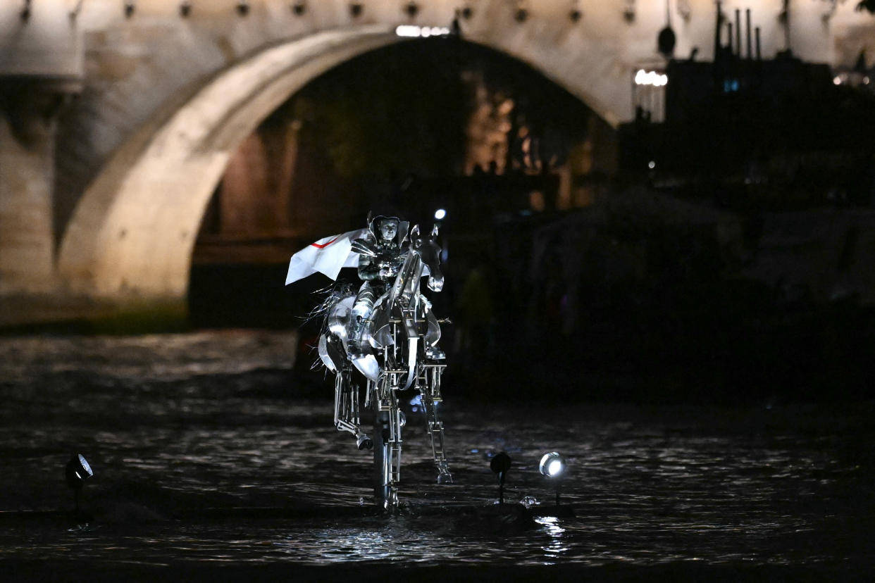 Floriane Issert, a Gendarmerie non-commissioned officer of the National Gendarmerie, rides on a metal horse up the Seine river past the Cassation Court and Conciergerie, during the opening ceremony of the Paris 2024 Olympic Games in Paris on July 26, 2024. (Photo by Kirill KUDRYAVTSEV / AFP) (Photo by KIRILL KUDRYAVTSEV/AFP via Getty Images)