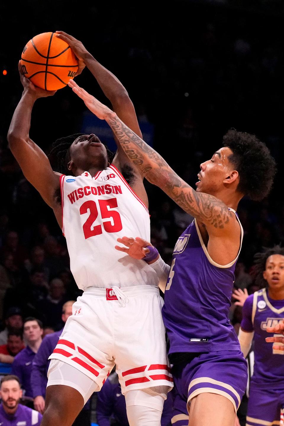 Wisconsin Badgers guard John Blackwell (25) shoots the ball against James Madison Dukes guard Terrence Edwards Jr. (5) in the first round of the 2024 NCAA Tournament at the Barclays Center in Brooklyn, New York