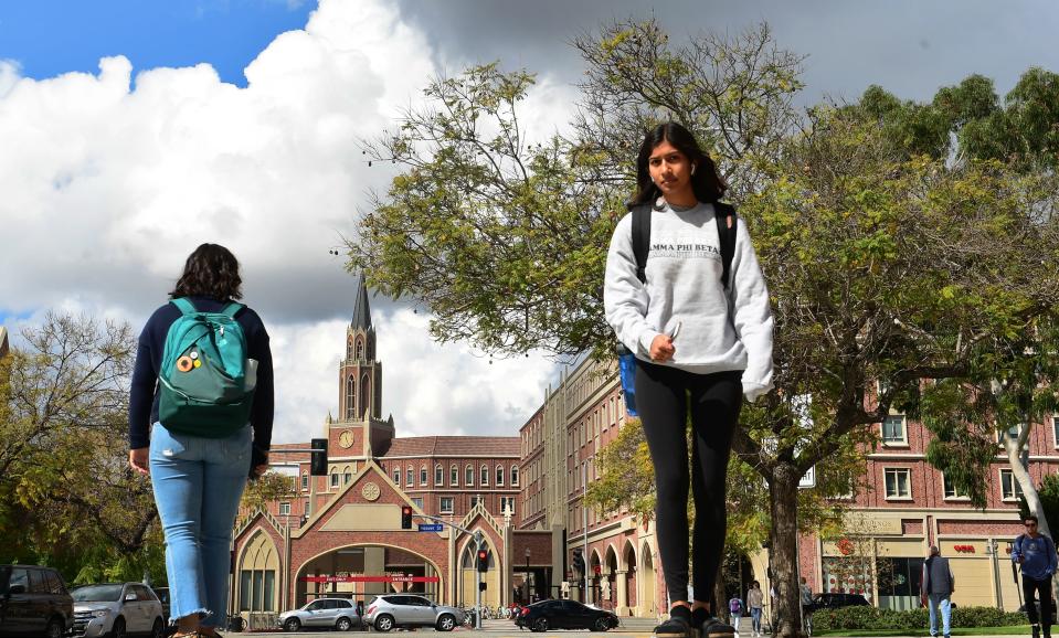 Students walk on the campus at the University of Southern California (USC) in Los Angeles, California on March 11, 2020, where a number of southern California universities, including USC, have suspended in-person classes due to coronavirus concerns. (Photo by Frederic J. BROWN / AFP) (Photo by FREDERIC J. BROWN/AFP via Getty Images)