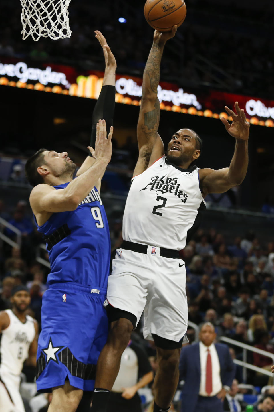 Los Angeles Clippers forward Kawhi Leonard (2) drives to the hoop for a dunk over Orlando Magic center Nikola Vucevic (9) during the second quarter of an NBA basketball game in Orlando, Fla., Sunday, Jan. 26, 2020. (AP Photo/Reinhold Matay)