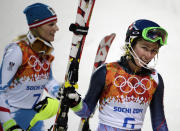Austria's Marlies Schild, left, and United States' Mikaela Shiffrin leave the finish area after winning silver and gold in the women's slalom at the Sochi 2014 Winter Olympics, Friday, Feb. 21, 2014, in Krasnaya Polyana, Russia. (AP Photo/Gero Breloer)
