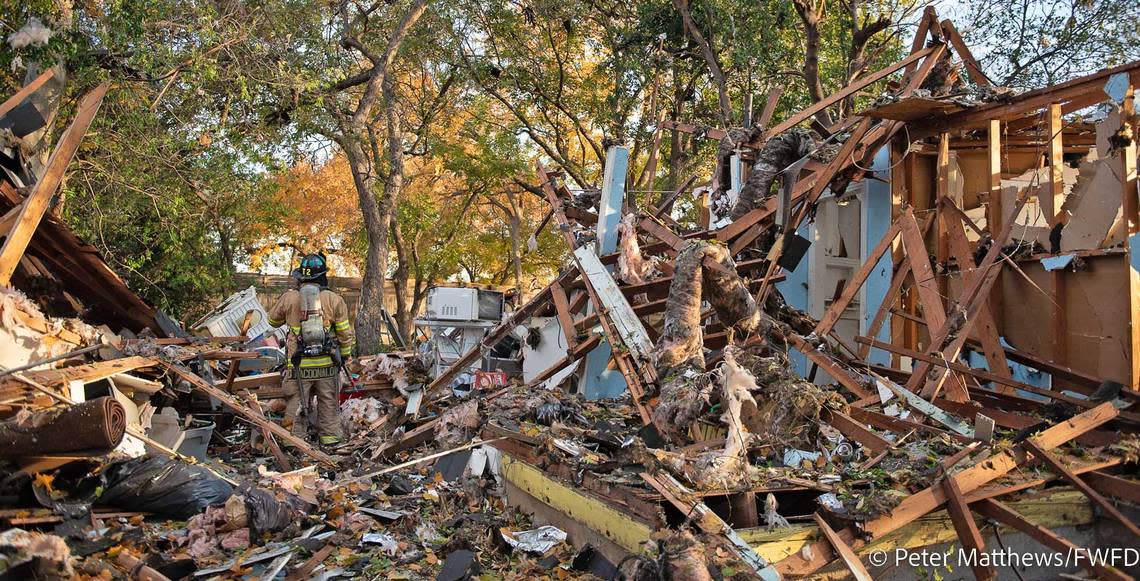 A firefighter stands in the debris of a home that exploded in Westworth Village on Dec. 1, 2022.