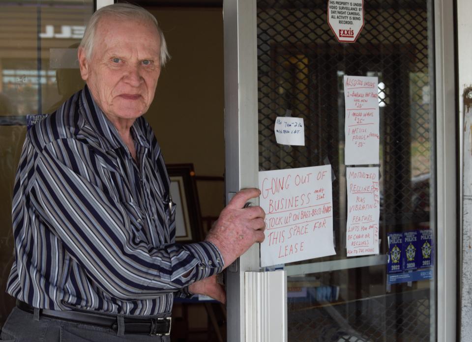 Wolfgang Heyn, owner of The Vac Shoppe on North Elizabeth Street, stands at the store's entrance where a sign informs customers the shop will close at the end of May.