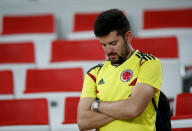 <p>Colombia fan looks dejected after losing the penalty shootout. REUTERS/Carl Recine </p>