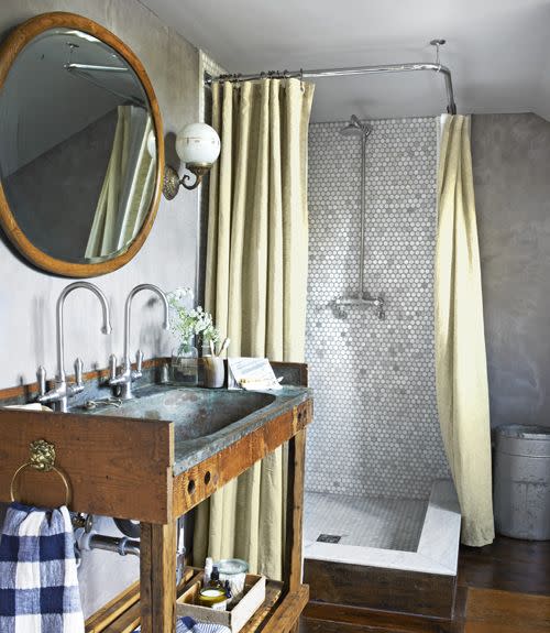 corner shower with gray marble hexagon tile walls, wrap around shower curtain, rustic wood farmhouse vanity