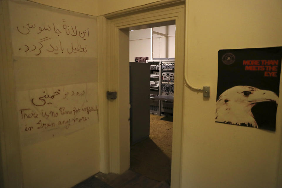 In this Sept. 26, 2019 photo, anti-U.S. slogans are written on the wall of a corridor of the former U.S. Embassy, now partly a museum, in Tehran, Iran. Slogans in Persian read: "The den of espionage should be shut down" and another line honors Ayatollah Ruhollah Khomeini who became supreme leader of Iran after returning from exile in France earlier in 1979. The slogan in English reads: "There is no time for intervention in Iran anymore." (AP Photo/Vahid Salemi)