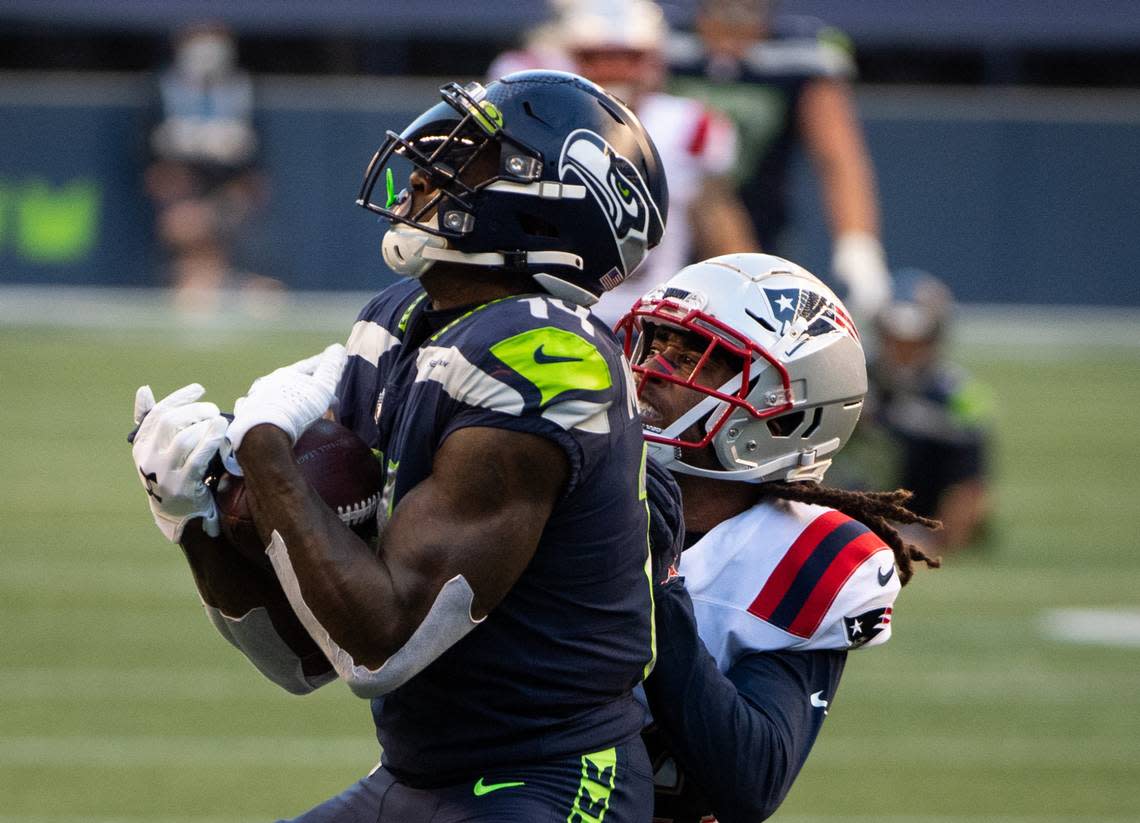 Seattle Seahawks wide receiver DK Metcalf (14) makes a catch for a touchdown while defended by New England Patriots cornerback Stephon Gilmore (24) during the second quarter. The Seattle Seahawks played the New England Patriots in a NFL football game at CenturyLink Field in Seattle, Wash., on Sunday, Sept. 20, 2020.