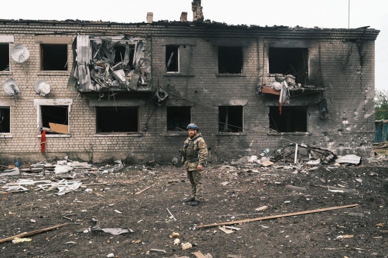 A Ukrainian police officer inspects a damaged building during the evacuation of local people from territories bordering Russia, in the city of Vovchansk, Kharkiv region, northeastern Ukraine, Monday, amid the Russian invasion. Photo By George Ivanchenko/EPA-EFE
