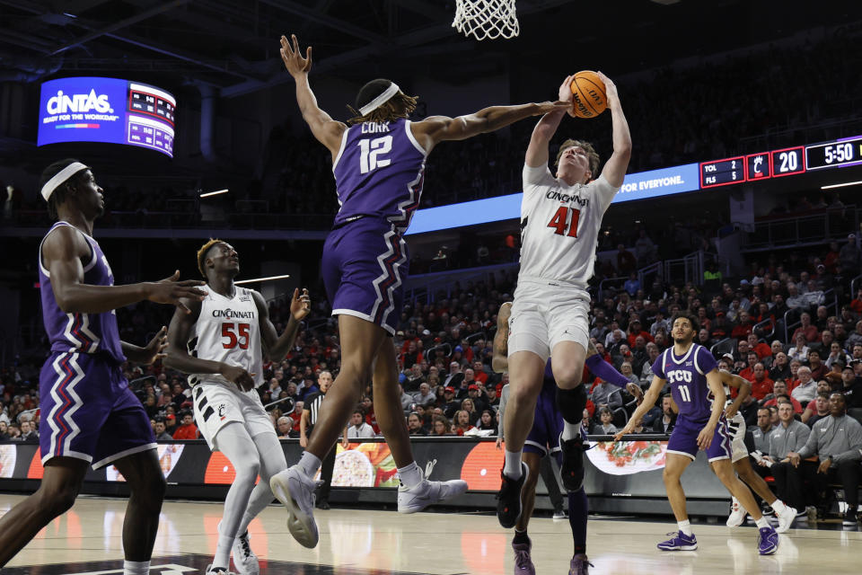 Cincinnati's Simas Lukosius, right, tries to shoot over TCU's Xavier Cork during the first half of an NCAA college basketball game Tuesday, Jan. 16, 2024, in Cincinnati. (AP Photo/Jay LaPrete)