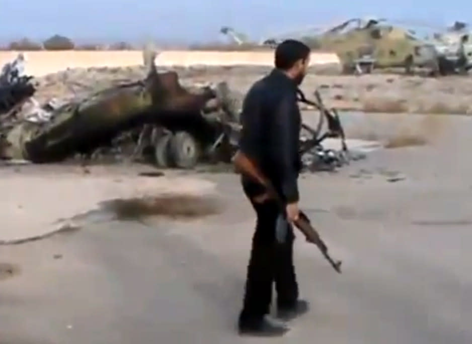 In this image taken from video obtained from the Ugarit News, which has been authenticated based on its contents and other AP reporting, Syrian rebels capture a helicopter air base near the capital Damascus after fierce fighting in Syria, on Sunday, Nov. 25, 2012. The takeover claim showed how rebels are advancing in the area of the capital, though they are badly outgunned by Assad’s forces, making inroads where Assad’s power was once unchallenged. Rebels have also been able to fire mortar rounds into Damascus recently. (AP Photo/Ugarit News via AP video)