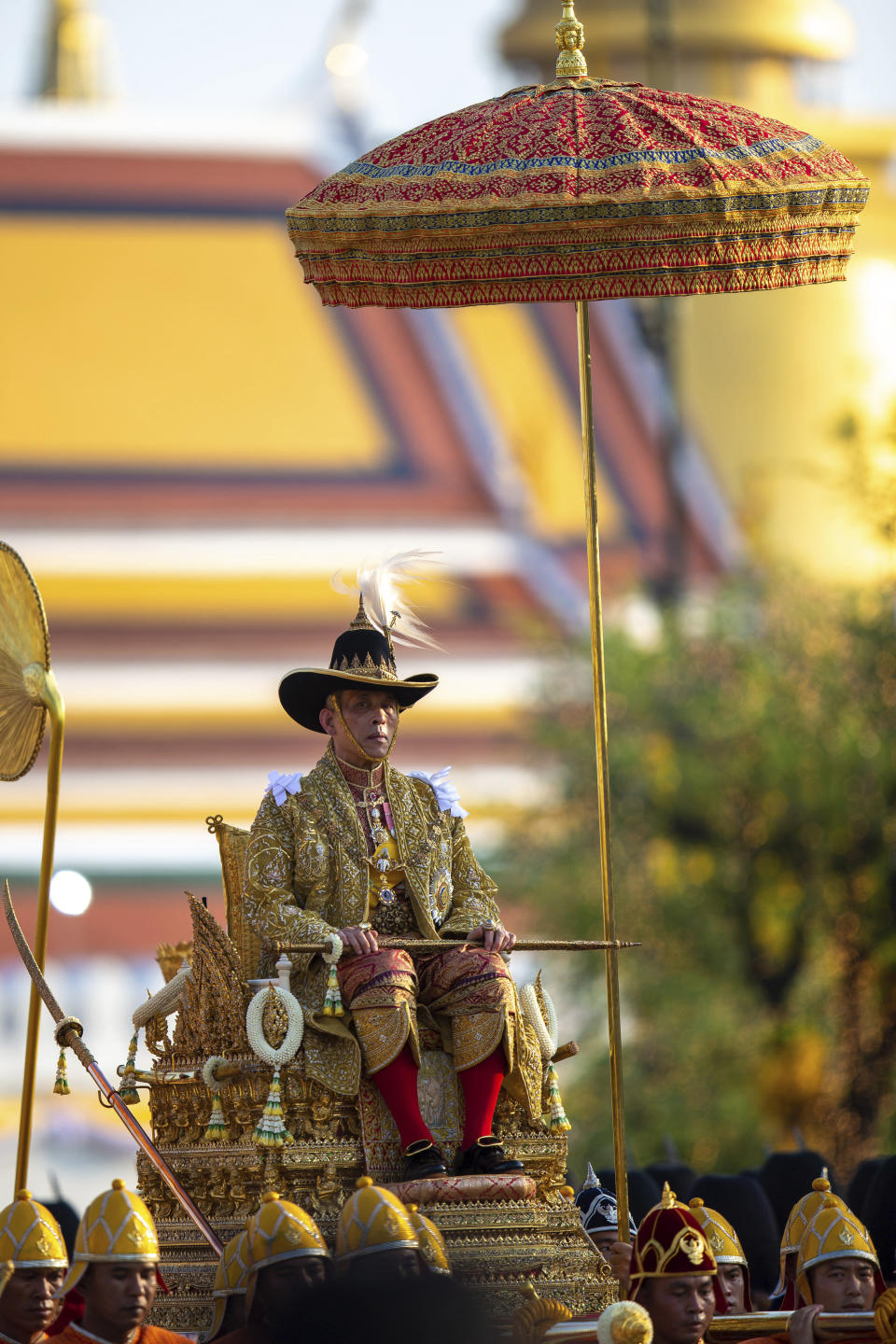 Thailand’s King Maha Vajiralongkorn is carried on a palanquin through the streets outside the Grand Palace for the public to pay homage during the second day of his coronation ceremony in Bangkok, Sunday, May 5, 2019. Vajiralongkorn was officially crowned Saturday amid the splendor of the country's Grand Palace, taking the central role in an elaborate centuries-old royal ceremony that was last held almost seven decades ago. (AP Photo/Wason Wanichorn)