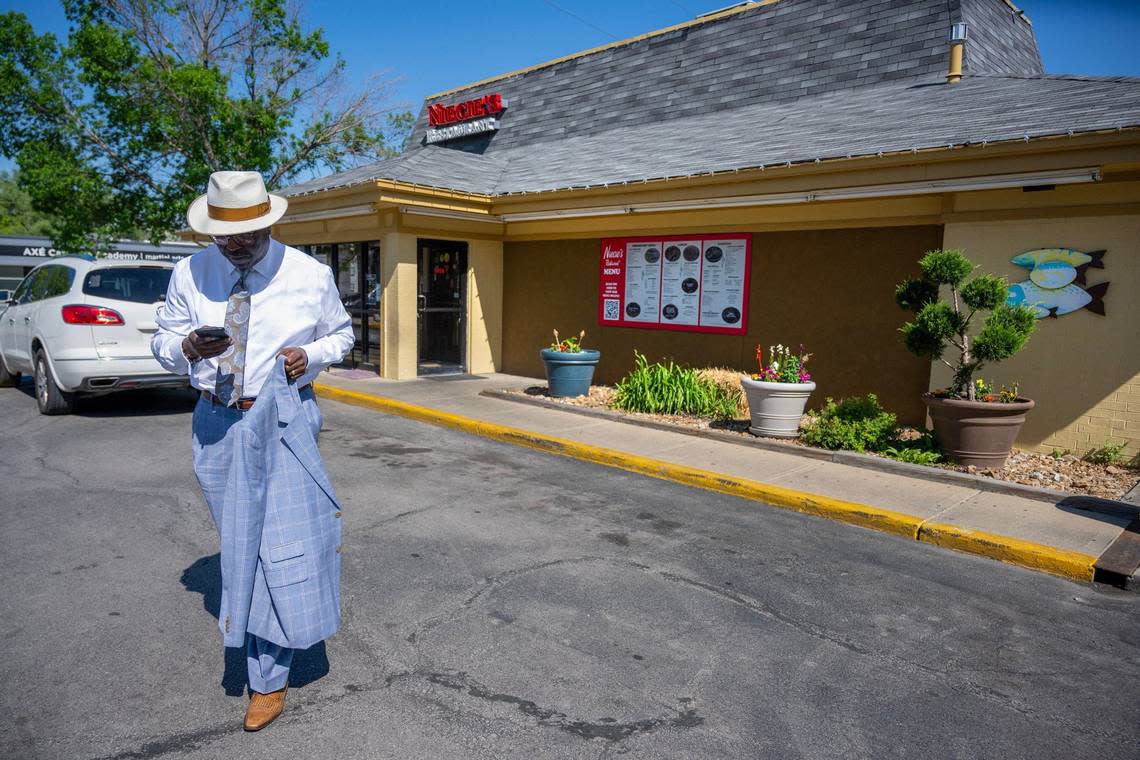 Bob Kendrick, president of the Negro Leagues Baseball Museum, checks his phone as he leaves Niecie’s Restaurant, 6441 Troost Ave. Tammy Ljungblad/Tljungblad@kcstar.com