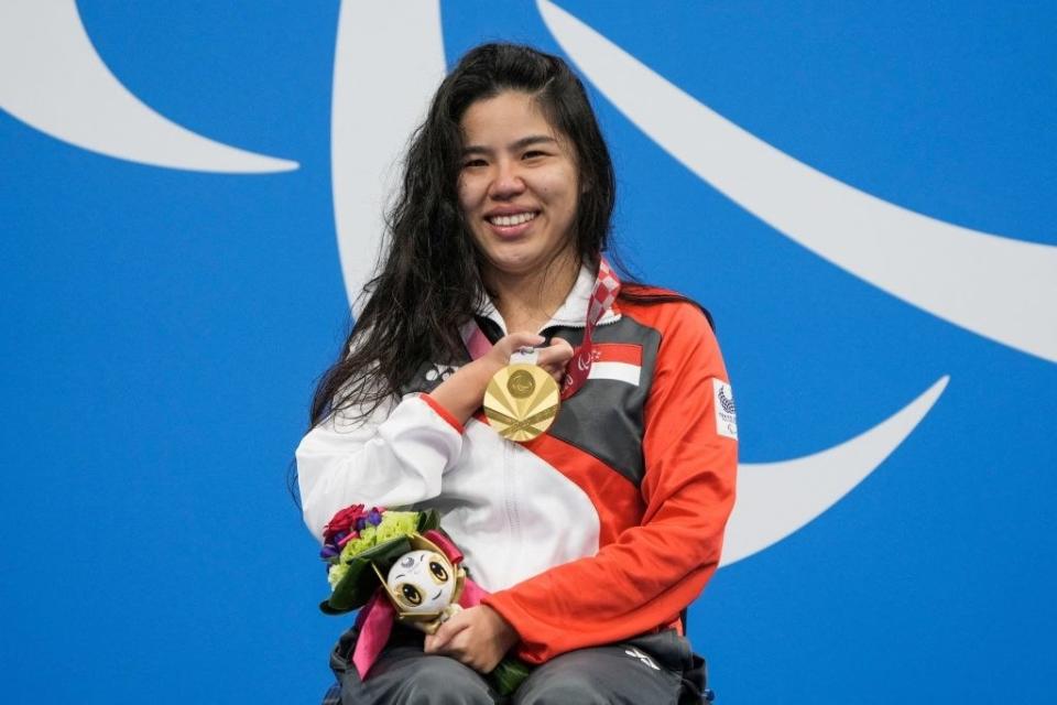 Yip Pin Xiu celebrates on the podium after the women's 100m backstroke swimming event during the Tokyo 2020 Paralympic Games