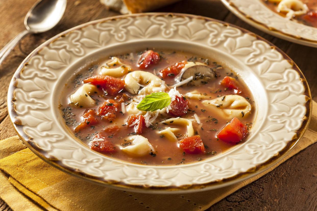 Tortellini Soup on off white deep plate with ornate decoration