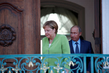 German Chancellor Angela Merkel and Russian President Vladimir Putin arrive to address the media before a meeting at the German government guest house Meseberg Palace in Gransee, Germany August 18, 2018. REUTERS/Axel Schmidt