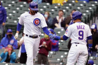 Chicago Cubs' Kris Bryant, left, is greeted by Javier Baez (9) after scoring against the Los Angeles Dodgers during the first inning of the first baseball game of a doubleheader Tuesday, May, 4, 2021, in Chicago. (AP Photo/David Banks)