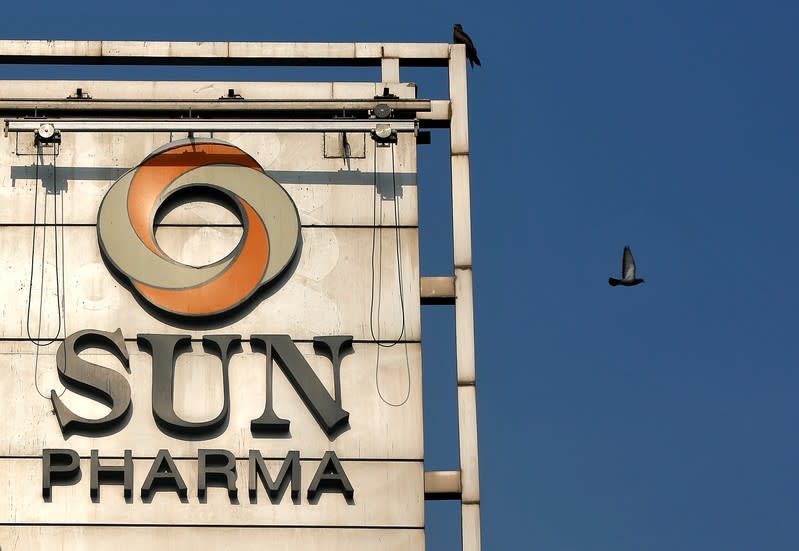 A bird flies past the logo of Sun Pharma installed on the facade of its corporate office in Mumbai