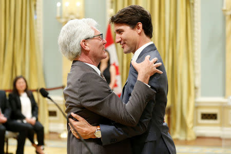 Canada's Prime Minister Justin Trudeau congratulates Jim Carr after he was sworn-in as Minister of International Trade Diversification during a cabinet shuffle at Rideau Hall in Ottawa, Ontario, Canada, July 18, 2018. REUTERS/Chris Wattie