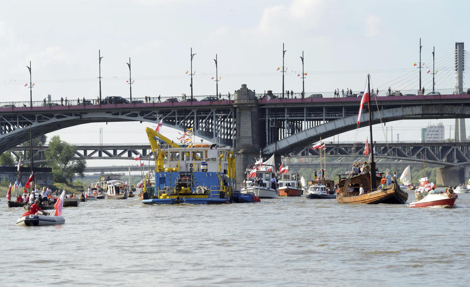 People in boats take part in a parade on the Vistula river to mark the 74th anniversary of the 1944 Warsaw Rising against the Nazi German occupiers, in Warsaw, Poland, Wednesday, Aug. 1, 2018. (AP Photo/Alik Keplicz)