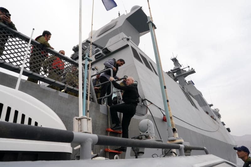 Israeli Minister of Defence Yoav Gallant climbs up the Sa'ar 6-class corvette of the Israeli Navy, during a visit to the Navy commanders and soldiers operating in the Red Sea in the vicinity of the city of Eilat. Ariel Hermoni/Israeli Ministry of Defence/dpa