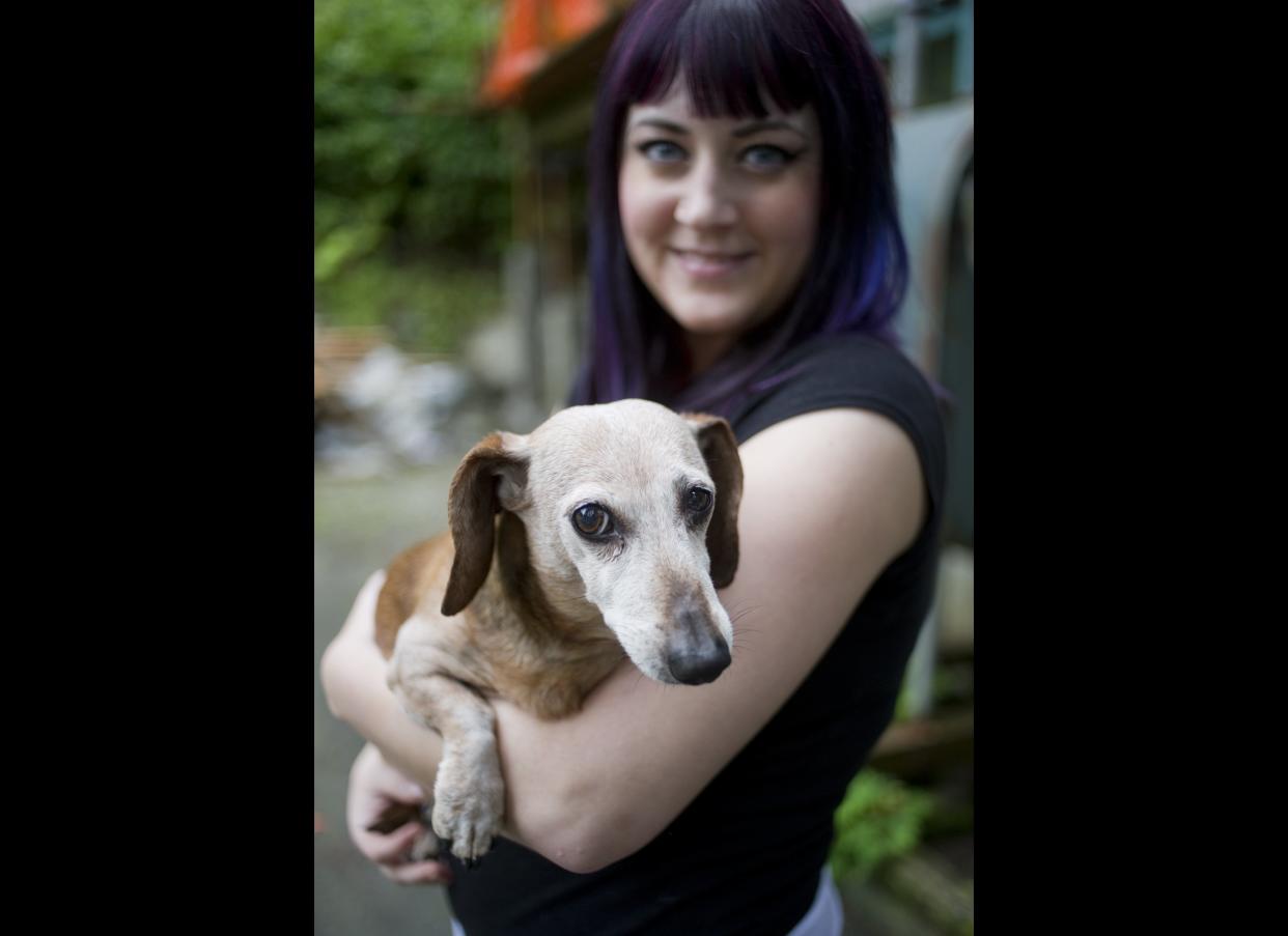 Brook Collins holds her dog, Fudge, at her home in Juneau, Alaska on Tuesday, Aug. 30, 2011. Collins punched a black bear in the snout after the bear attacked Fudge on Sunday, Aug. 28.