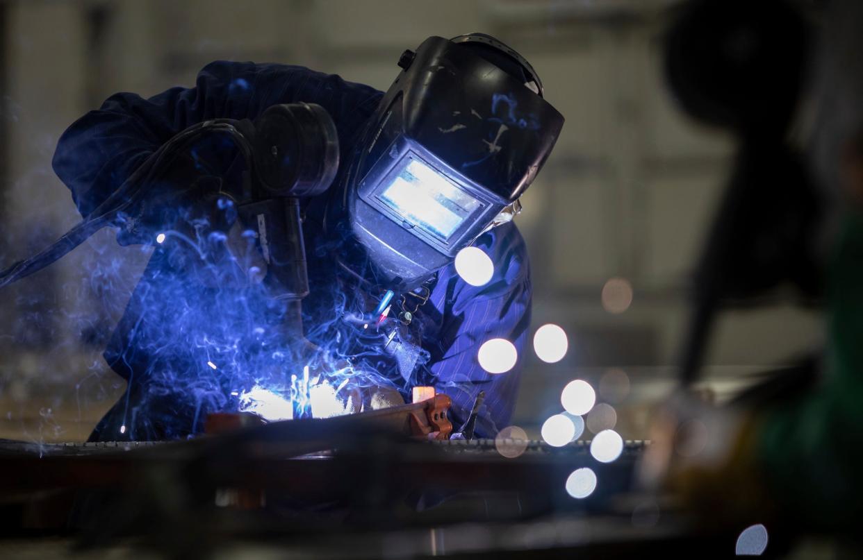 A man is pictured welding in February in Detroit. The welding goggles he wears are suitable to protect his eyes from the light and heat he's generating, but unless they're Shade 12 or higher, they're not safe to wear to view a total solar eclipse.