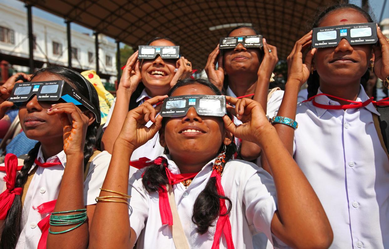 2010: People observe an annular eclipse in Thiruvananthapuram, Kerala, South India. 