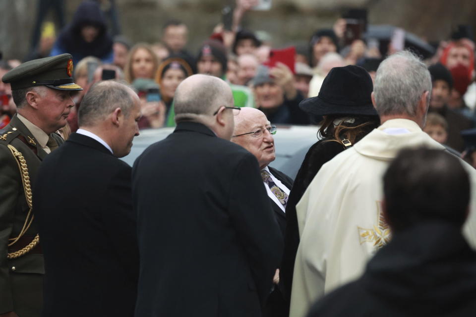 Ireland's President Michael D. Higgins, center, arrives for the funeral of Shane MacGowan at Saint Mary's of the Rosary Church, Nenagh, Ireland, Friday, Dec. 8, 2023. MacGowan, the singer-songwriter and frontman of The Pogues, best known for their ballad “Fairytale of New York,” died on Thursday, Nov. 30, 2023. He was 65. (Niall Carson/PA via AP)