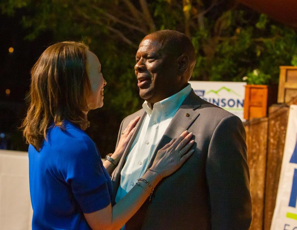 Michele Halyard congratulates her husband, Kevin Robinson, after results of his victory broke during his watch party at Aunt Chilada's in Phoenix on Tuesday, March 14, 2023.