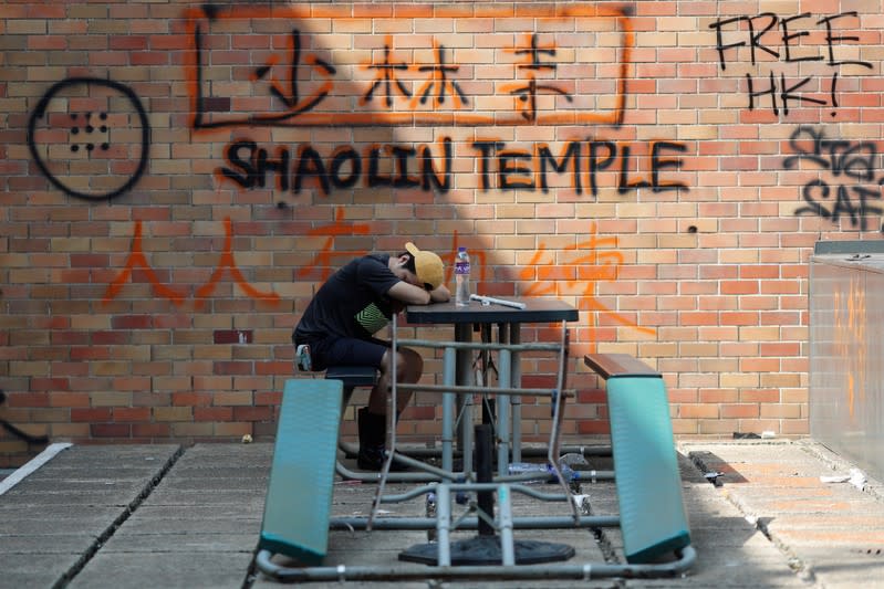 An anti-government demonstrator rests during protests at the Polytechnic University in Hong Kong