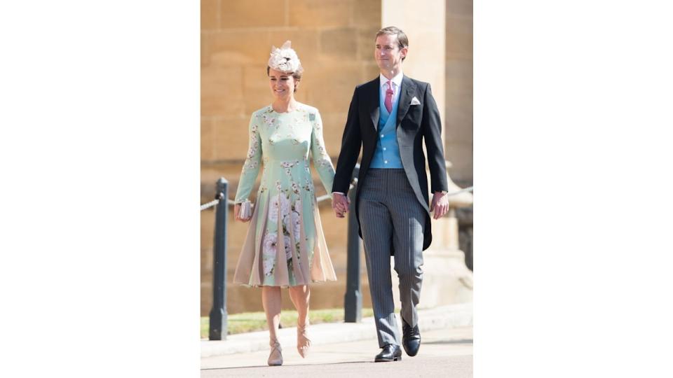 Pippa Middleton in a green floral dress holding hands with James Matthews