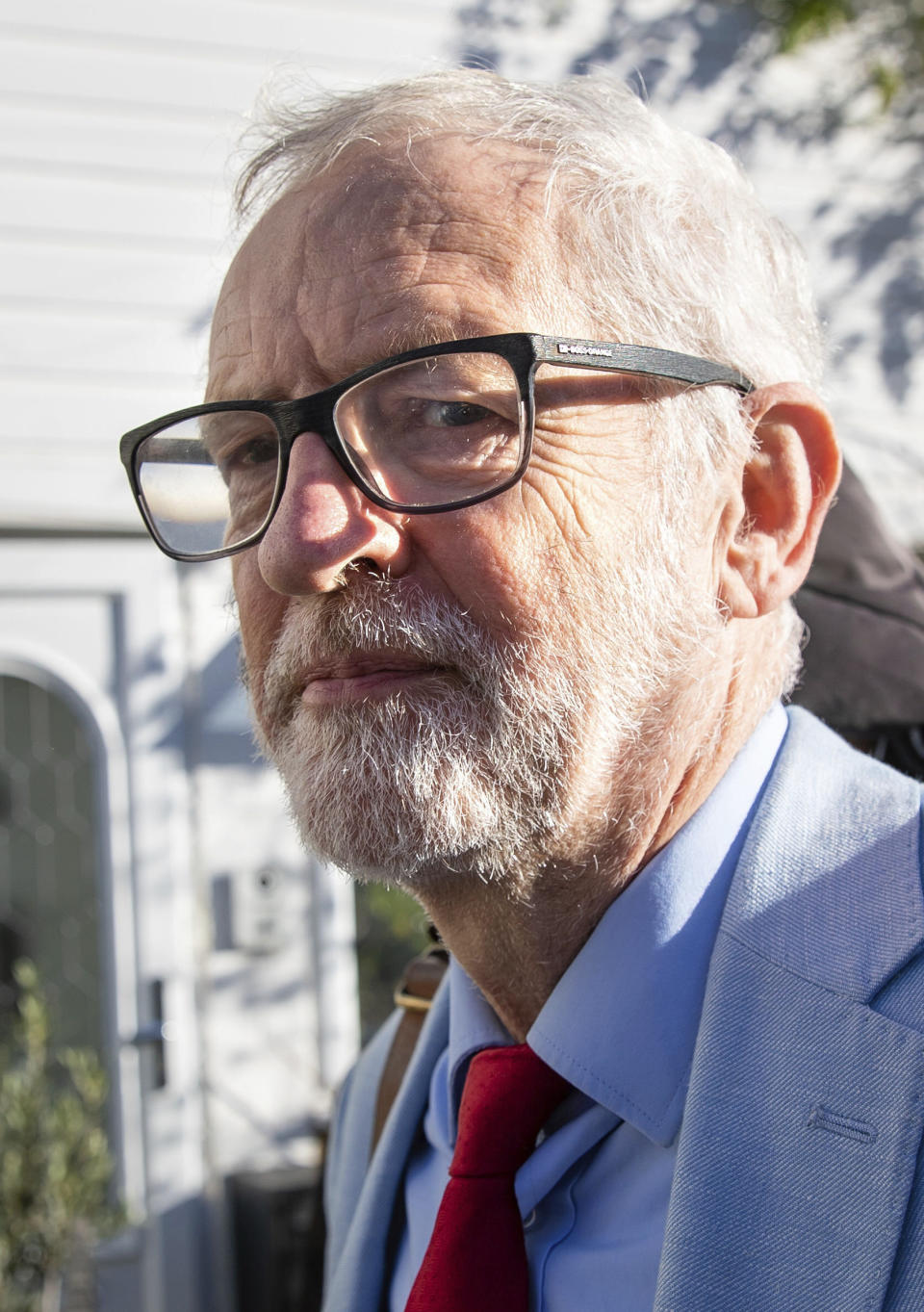 Britain's former opposition Labour Party leader Jeremy Corbyn leaves his home in London, Wednesday Nov. 18, 2020. Corbyn will be reinstated into the political party it is announced Wednesday after a three-week suspension as Labour’s National Executive Committee seeks to draw a line under years of tumultuous divisions over alleged anti-Jewish prejudice in the party. (Aaron Chown/PA via AP)