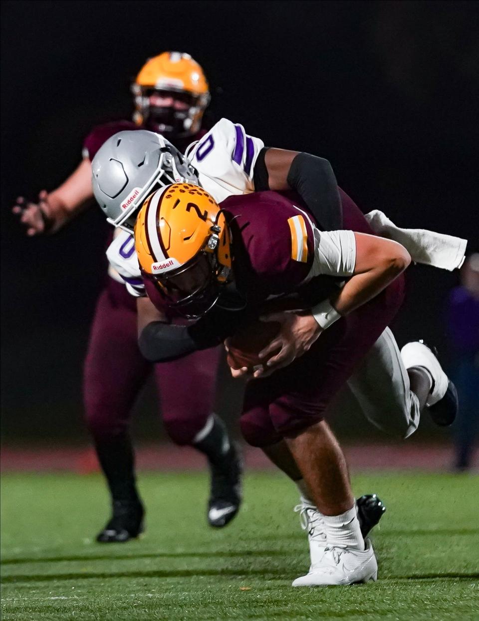 Bloomington South’s Ralph Rogers (0) tackles Bloomington North’s Dash King (2) during the IHSAA sectional semi-final football game at Bloomington North on Friday, Oct. 27, 2023.
