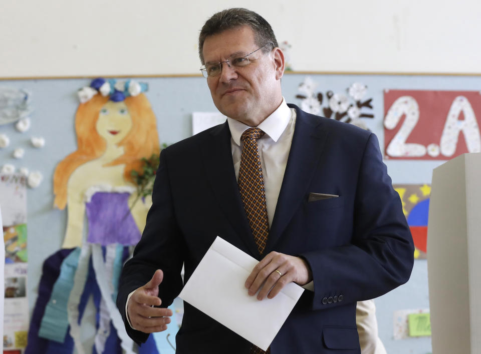 In this file picture taken on Saturday, March 16, 2019, Presidential candidate Maros Sefcovic prepares to cast his vote at a polling station during the first round of the presidential election in Bratislava, Slovakia. Slovakia could get its first woman president as voters elect a new head of state on Saturday March 30. The leading contenders are Zuzana Caputova, an environmental activist who is in favor of gay rights and opposes a ban on abortion in this conservative Roman Catholic country, and Maros Sefcovic, an establishment figure who is the European Commission Vice-President. (AP Photo/Petr David Josek/File)