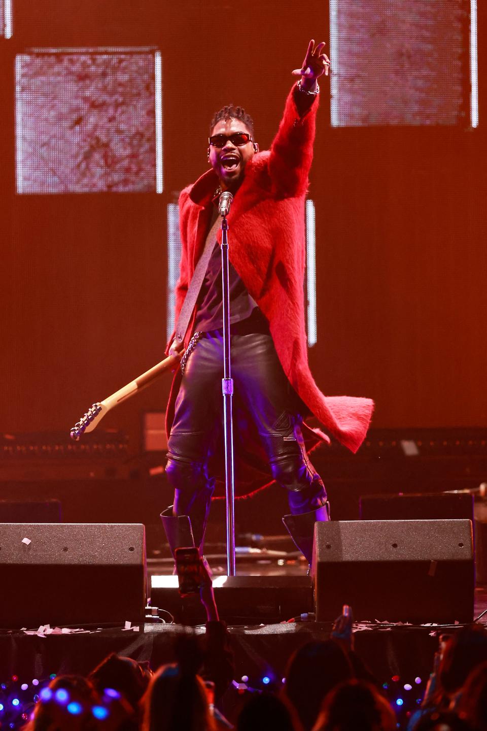 Donning a knee-length red coat to the Jingle Ball stage, Miguel gave off rocker Santa vibes.