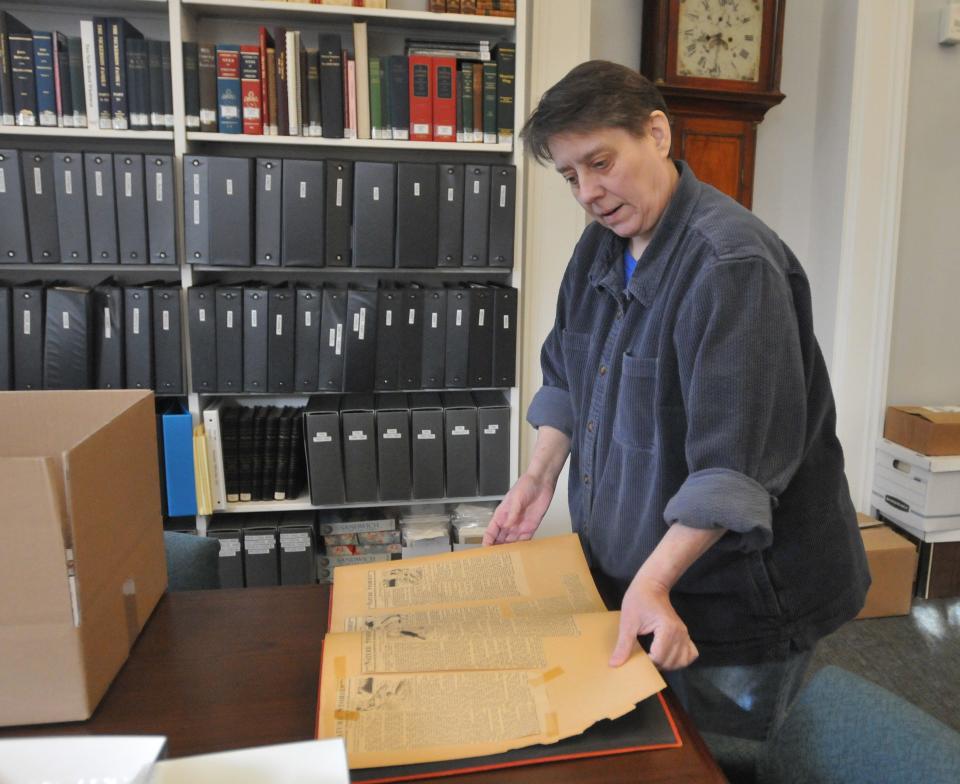 Sandwich town archivist and reference librarian Deborah Rich pages through a scrapbook with newspaper clippings of stories by Thornton Burgess. The scrapbook is part of the town's archives. Sandwich is celebrating the 150th birthday year of renowned author and conservationist Thornton Burgess, a Sandwich native.