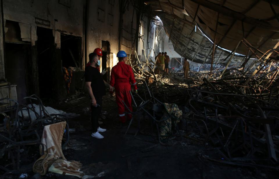 Firefighters work at the site of a fatal fire, in the district of Hamdaniya, Nineveh province, Iraq, Wednesday, Sept. 27, 2023. A fire that raced through a hall hosting a Christian wedding in northern Iraq killed multiple people, authorities said Wednesday.