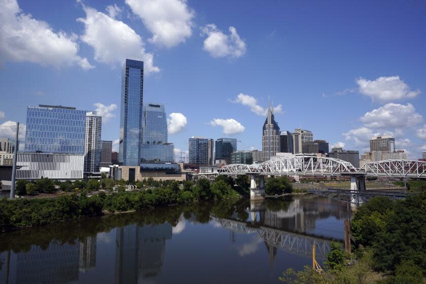 The Nashville, Tenn., skyline is reflected in the Cumberland River July 11, 2022. (AP Photo/Mark Humphrey)