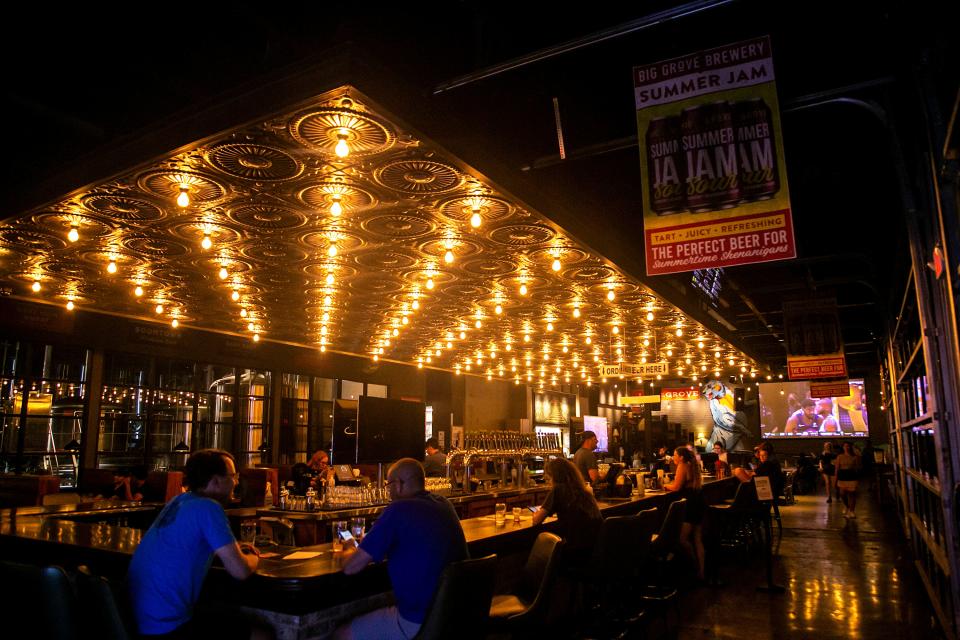 Customers sit at the bar at Big Grove Brewery & Taproom in Iowa City.