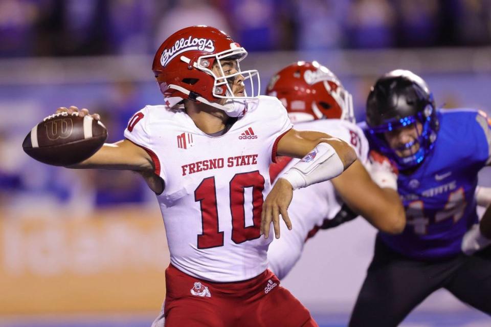 Fresno State quarterback Logan Fife (10) looks to throw the ball against Boise State during the first half of an NCAA college football game Saturday, Oct. 8, 2022, in Boise, Idaho. (AP Photo/Steve Conner)