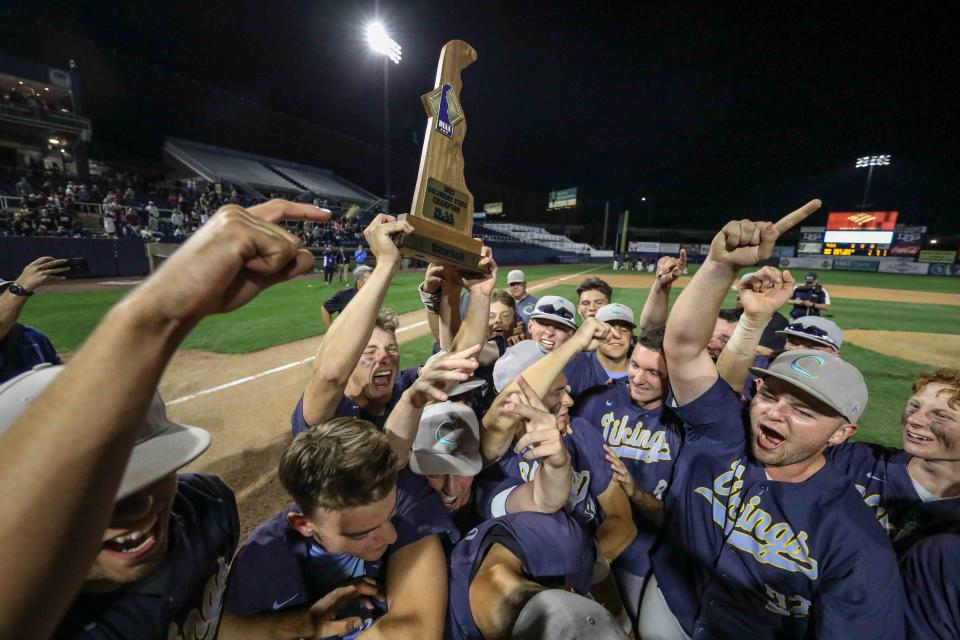 Cape Henlopen players celebrate with the trophy after a 4-1 win over Appoquinimink in the DIAA Baseball championship game Monday night at Frawley Stadium.