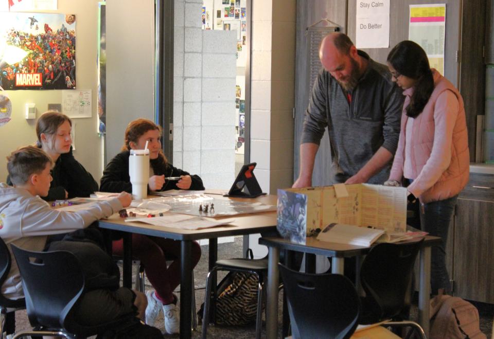 Kade Wells helps dungeon masters oversee their Dungeons & Dragons games in his classroom at Harrisburg East Middle School on Friday, March 22, 2024.