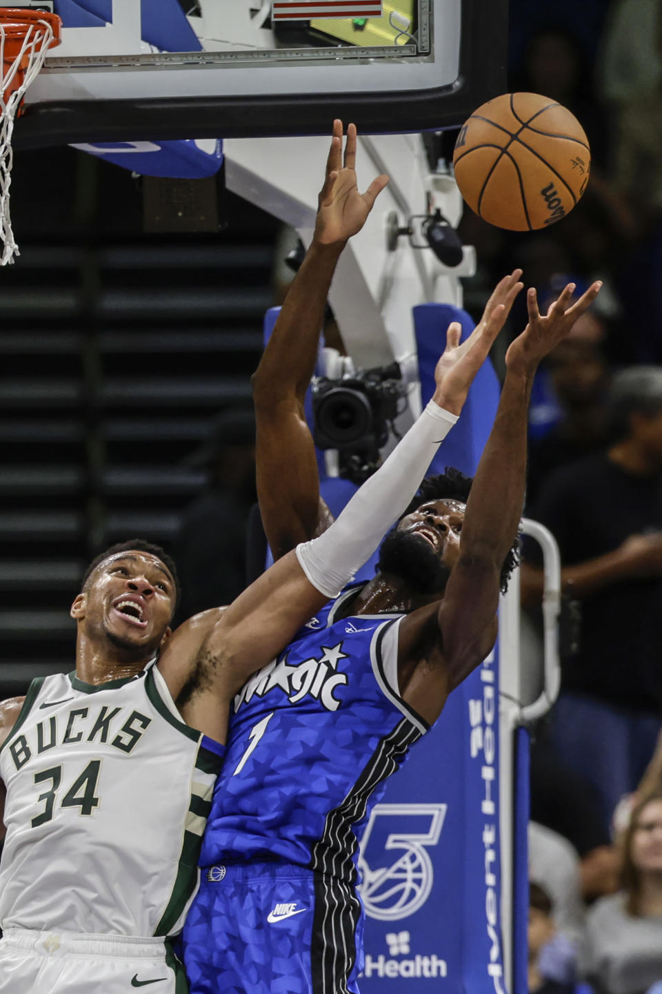 Orlando Magic forward Jonathan Isaac (1) and Milwaukee Bucks forward Giannis Antetokounmpo (34) reach for a rebound during the first half of an NBA basketball game Saturday, Nov. 11, 2023, in Orlando, Fla. (AP Photo/Kevin Kolczynski)