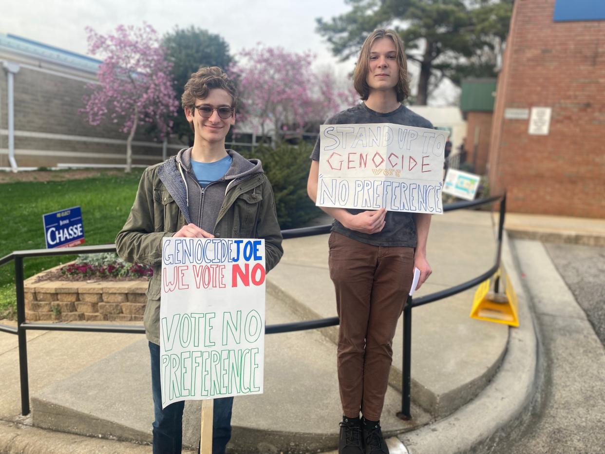 Isaac Hedges and John Hanlon, members of the Youth Democratic Socialists of America, stood with signs in front of a Raleigh polling location on primary election day 2024 encouraging people to vote 'no preference' in the Democratic primary over Joe Biden