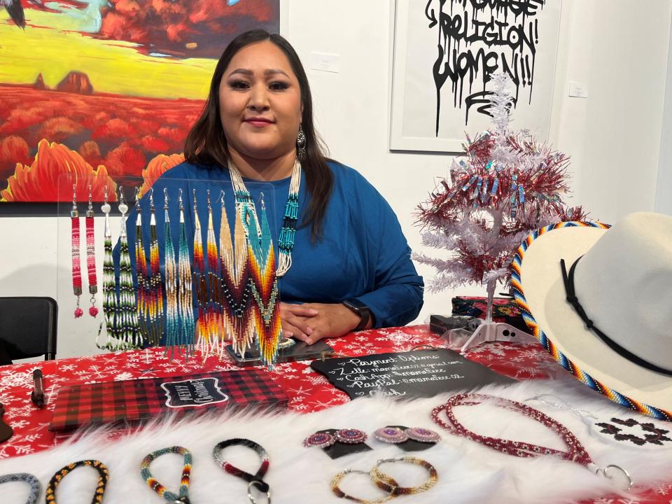 Artist and beadworker Tiffany Yazzie at the pop-up market at Cahokia SocialTech & Art Space in downtown Phoenix on Nov. 25, 2023.