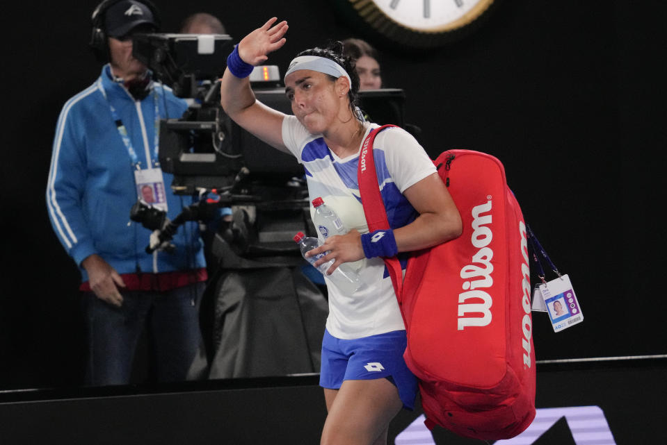 Ons Jabeur of Tunisia waves as she leaves Rod Laver Arena following her second round loss to Marketa Vondrousova of the Czech Republic at the Australian Open tennis championship in Melbourne, Australia, Friday, Jan. 20, 2023. (AP Photo/Dita Alangkara)