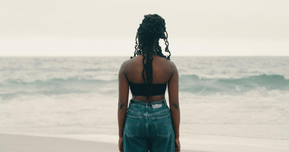 Shot of a young woman watching the ocean waves