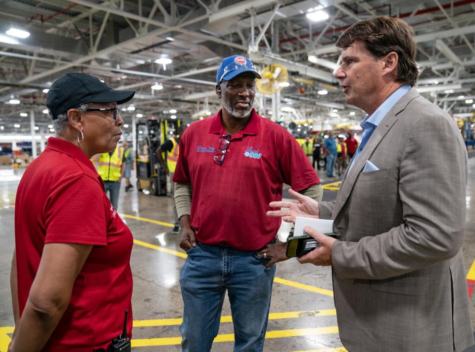 Cheryl Williams, of UAW Local 900, left, speaks with Deaono Felix, also of UAW 900, to Ford President and CEO Jim Farley before he and DTE officials announced, at a news conference in the Wayne Ford Michigan Assembly Plant Modification Center on Aug. 10, 2022, a historical deal between the two entities where Ford will be powering all its Michigan factories with sustainable energy.