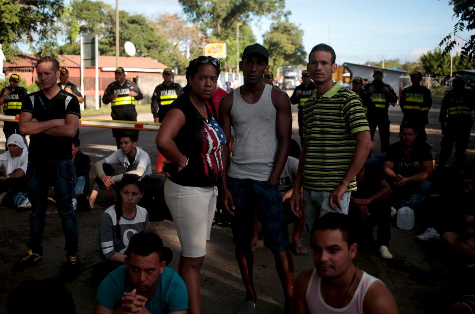 Cubans migrants protest in front of policemen as they wait for the opening of the border between Costa Rica and Nicaragua in Penas Blancas, Costa Rica November 17, 2015. More than a thousand Cuban migrants hoping to make it to the United States were stranded in the border town of Penas Blancas, Costa Rica, on Monday after Nicaragua closed its border on November 15, 2015 stoking diplomatic tensions over a growing wave of migrants making the journey north from the Caribbean island. REUTERS/Oswaldo Rivas