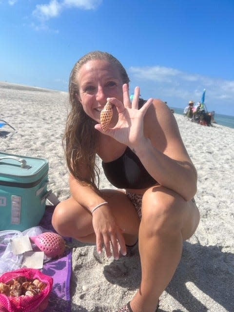 Torie Costilow shows off one of the two  junonia shells she found recently on Sanibel.